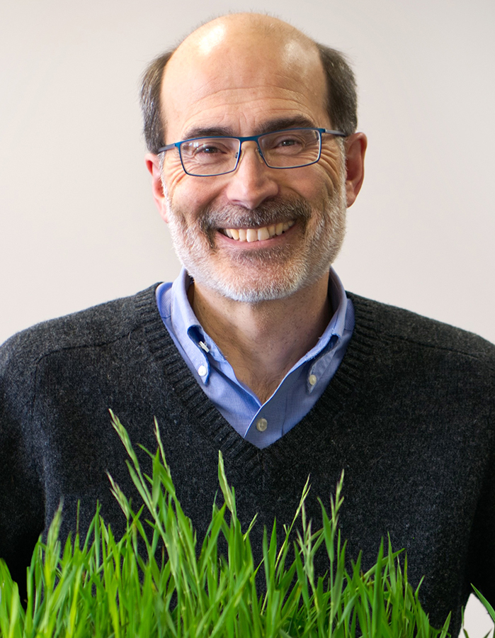 photo of Rick Amasino holding grass plants
